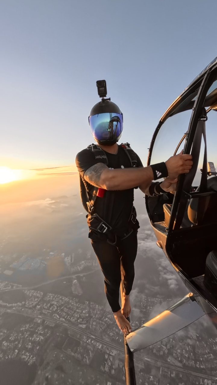 Kyle on the helicopter skid at sunset